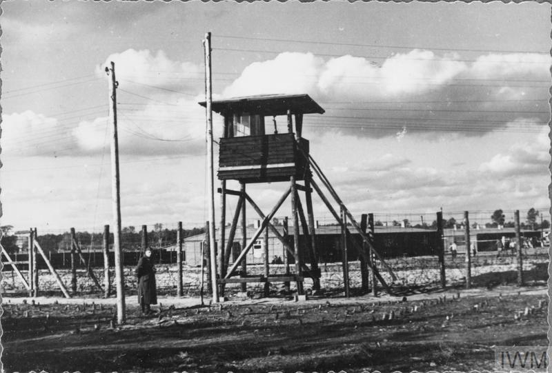 A German guard by one of the watch towers at Stalag Luft III, Sagan. © IWM (HU 21024)